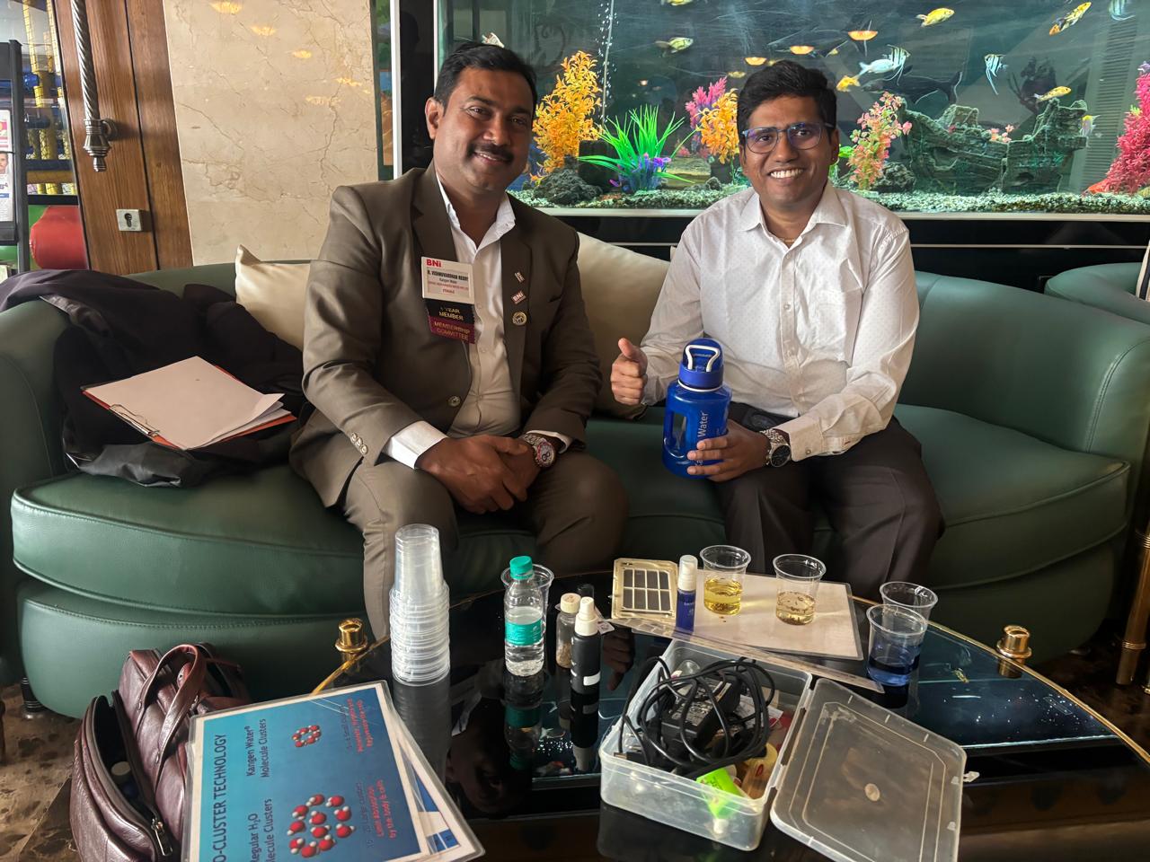 Happy customer holding a Kangen Water bottle after a demonstration